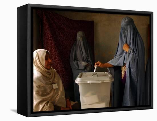 An Afghan Woman Wearing a Burqa Casts Her Ballot at a Polling Station-null-Framed Stretched Canvas