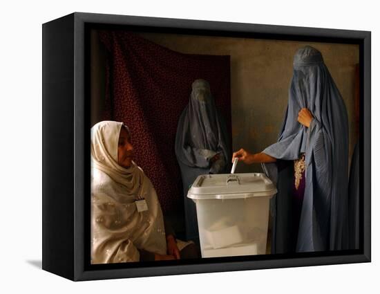 An Afghan Woman Wearing a Burqa Casts Her Ballot at a Polling Station-null-Framed Stretched Canvas