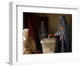 An Afghan Woman Wearing a Burqa Casts Her Ballot at a Polling Station-null-Framed Photographic Print