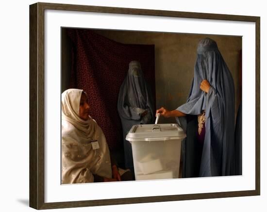 An Afghan Woman Wearing a Burqa Casts Her Ballot at a Polling Station-null-Framed Photographic Print