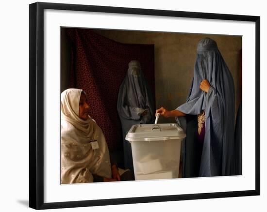 An Afghan Woman Wearing a Burqa Casts Her Ballot at a Polling Station-null-Framed Photographic Print