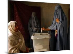 An Afghan Woman Wearing a Burqa Casts Her Ballot at a Polling Station-null-Mounted Photographic Print