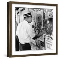 An African American Pokes His Finger into a Bullet Hole in the Oakland Black Panther's Headquarters-null-Framed Photo