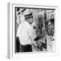 An African American Pokes His Finger into a Bullet Hole in the Oakland Black Panther's Headquarters-null-Framed Photo