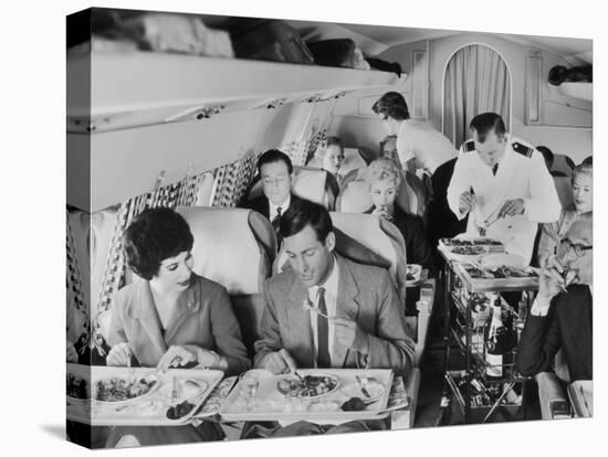 An Airline Steward and Air Hostess Serve a Roast Meal to Flight Passengers-null-Stretched Canvas