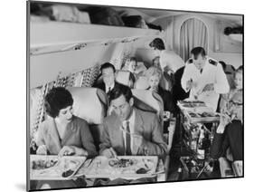 An Airline Steward and Air Hostess Serve a Roast Meal to Flight Passengers-null-Mounted Photographic Print
