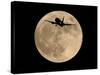 An Airliner is Silhouetted against a Full Moon-null-Stretched Canvas