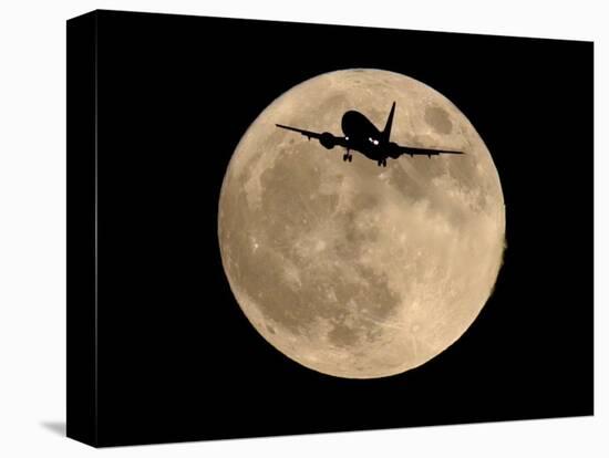 An Airliner is Silhouetted against a Full Moon-null-Stretched Canvas