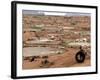 An Albanian Resident of Kukes Scavenges a Leftover Tractor Tire from a Vacant Refugee Camp-null-Framed Photographic Print