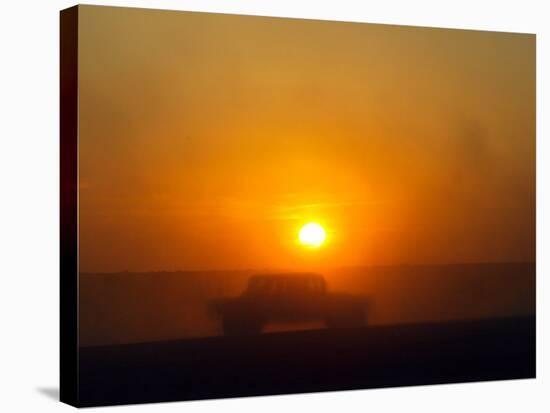 An American Humvee Drives Through the Desert at Sunset Near the Iraqi Border-null-Stretched Canvas