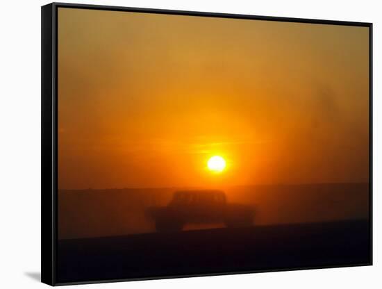 An American Humvee Drives Through the Desert at Sunset Near the Iraqi Border-null-Framed Stretched Canvas