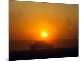 An American Humvee Drives Through the Desert at Sunset Near the Iraqi Border-null-Mounted Photographic Print