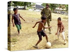An Australian Soldier Plays with Displaced East Timorese Children-null-Stretched Canvas