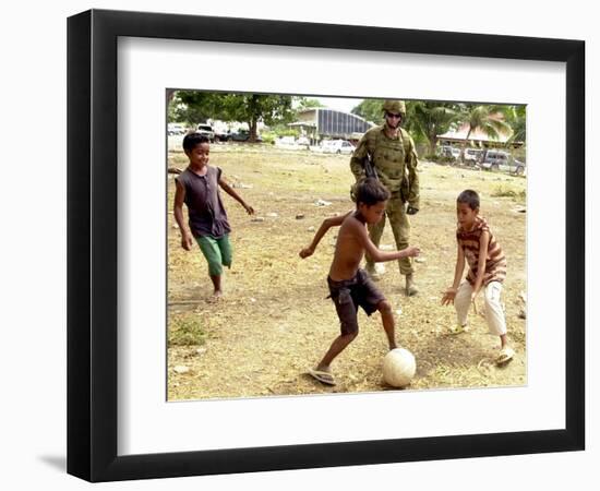 An Australian Soldier Plays with Displaced East Timorese Children-null-Framed Photographic Print