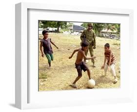 An Australian Soldier Plays with Displaced East Timorese Children-null-Framed Photographic Print