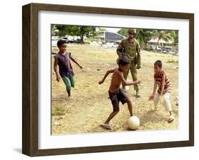 An Australian Soldier Plays with Displaced East Timorese Children-null-Framed Photographic Print