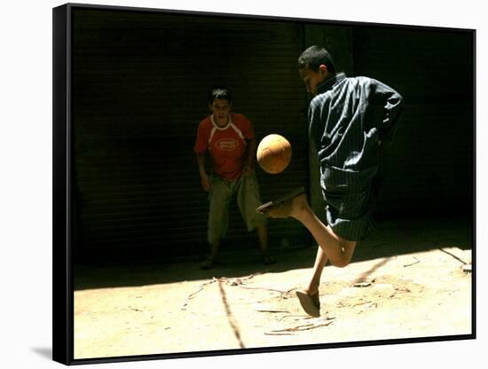 An Egyptian Boy Shows off His Ball Skill as He Plays Soccer with a Friend on the Steets of Cairo-null-Framed Stretched Canvas