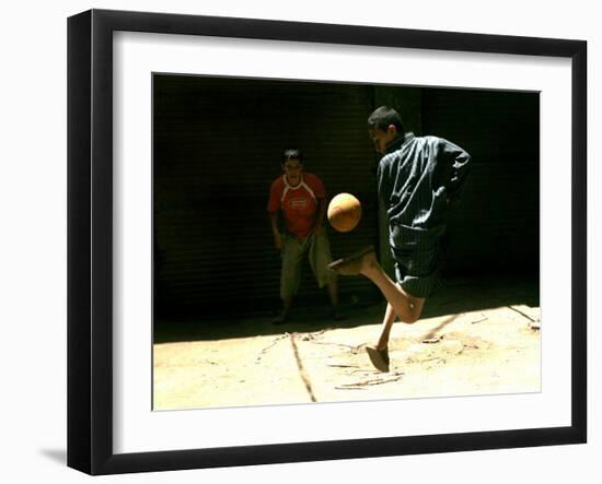 An Egyptian Boy Shows off His Ball Skill as He Plays Soccer with a Friend on the Steets of Cairo-null-Framed Premium Photographic Print