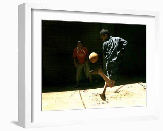 An Egyptian Boy Shows off His Ball Skill as He Plays Soccer with a Friend on the Steets of Cairo-null-Framed Premium Photographic Print