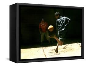 An Egyptian Boy Shows off His Ball Skill as He Plays Soccer with a Friend on the Steets of Cairo-null-Framed Stretched Canvas