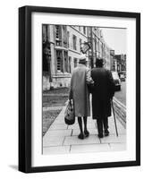 An Elderly Couple Walking Down the Street, Arm in Arm-Henry Grant-Framed Photographic Print