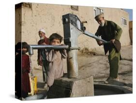 An Elderly Man Pumps Water from a Public Well in Kabul, Afghanistan, Friday, September 22, 2006-Rodrigo Abd-Stretched Canvas