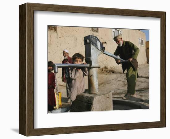 An Elderly Man Pumps Water from a Public Well in Kabul, Afghanistan, Friday, September 22, 2006-Rodrigo Abd-Framed Photographic Print