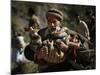 An Elderly Pakistani Earthquake Survivor Rushes Towards a Helicopter Carrying a Child in His Arms-null-Mounted Photographic Print