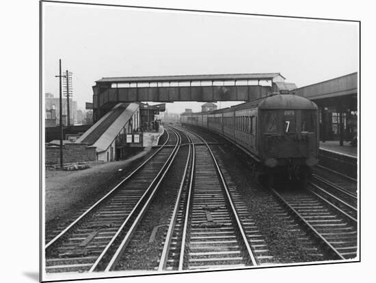 An Electric Train at Raynes Park Station Surrey England-null-Mounted Art Print