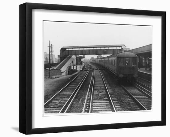 An Electric Train at Raynes Park Station Surrey England-null-Framed Art Print