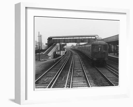 An Electric Train at Raynes Park Station Surrey England-null-Framed Art Print