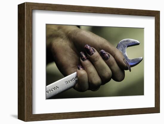 An Employee Holds a Spanner as She Works-Sergei Karpukhin-Framed Photographic Print