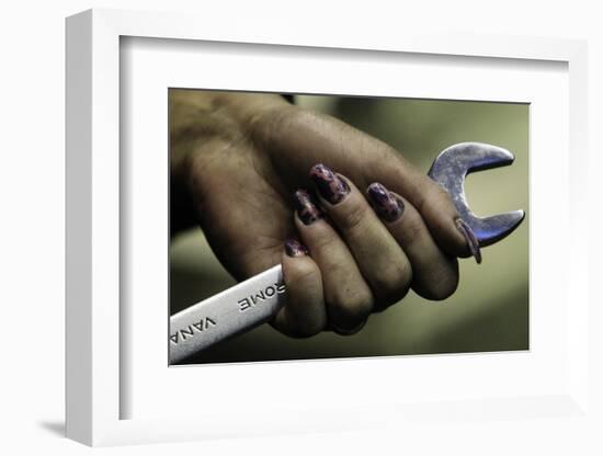 An Employee Holds a Spanner as She Works-Sergei Karpukhin-Framed Photographic Print