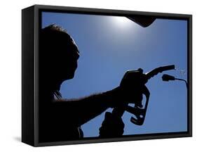 An Employee of a Petrol Station Holds a Petrol Pump after Filling up a Car-null-Framed Stretched Canvas