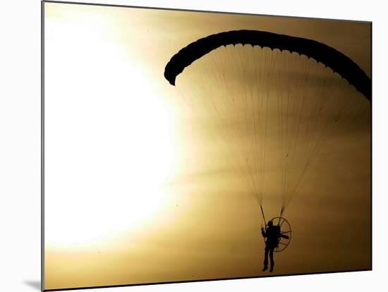 An Engine-Powered Paraglider Soars Through the Air Near Schlesen-null-Mounted Photographic Print