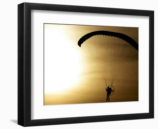 An Engine-Powered Paraglider Soars Through the Air Near Schlesen-null-Framed Photographic Print