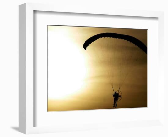 An Engine-Powered Paraglider Soars Through the Air Near Schlesen-null-Framed Photographic Print
