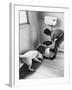 An Excited Army Sniffer Dog Sniffs under the Floorboards Near the Toilet-null-Framed Photographic Print