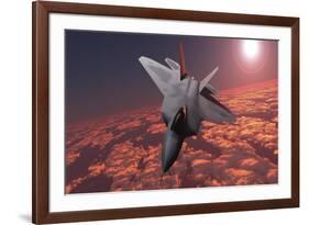 An F-22 Fighter Jet Flies at an Altitude Above the Cloud Layer on its Mission-null-Framed Art Print