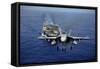 An F-A-18E Super Hornet Flying Above USS John C. Stennis-null-Framed Stretched Canvas