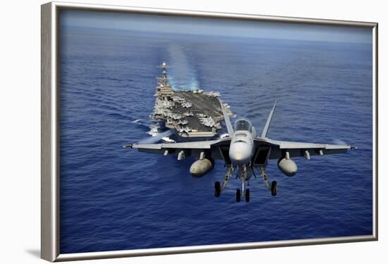 An F-A-18E Super Hornet Flying Above USS John C. Stennis-null-Framed Photographic Print