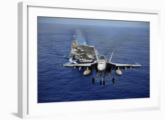 An F-A-18E Super Hornet Flying Above USS John C. Stennis-null-Framed Photographic Print