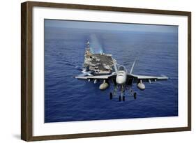 An F-A-18E Super Hornet Flying Above USS John C. Stennis-null-Framed Photographic Print