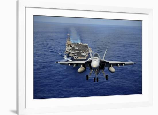 An F-A-18E Super Hornet Flying Above USS John C. Stennis-null-Framed Photographic Print