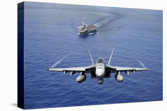 An F-A-18E Super Hornet Flying Above USS John C. Stennis-null-Stretched Canvas