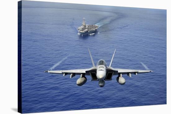 An F-A-18E Super Hornet Flying Above USS John C. Stennis-null-Stretched Canvas