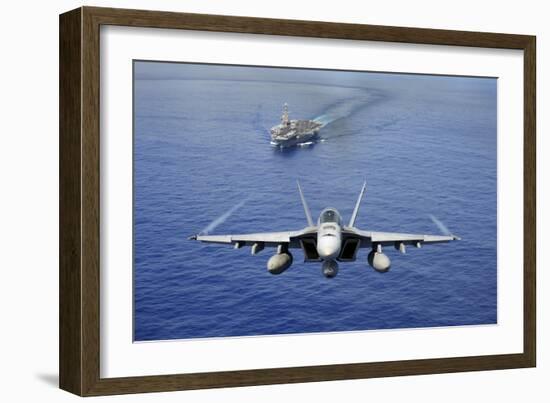 An F-A-18E Super Hornet Flying Above USS John C. Stennis-null-Framed Photographic Print