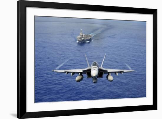 An F-A-18E Super Hornet Flying Above USS John C. Stennis-null-Framed Photographic Print