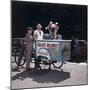 An Ice Cream Man Giving a Cone To a Child-null-Mounted Photographic Print