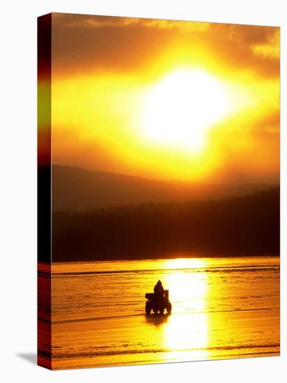 An Ice Fisherman Motors Across the Frozen Surface of Lake Champlain Near the Milton-South Hero, VT.-null-Stretched Canvas